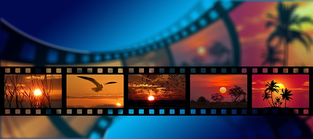 A strip of camera film against a blue background, gives the illusion that the film is moving, on the film there are three pictures of sunsets are are orange