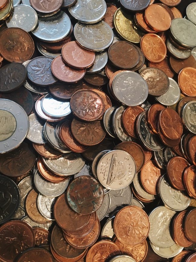 A zoomed in picture of hundreds of coins