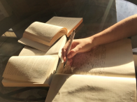 Writing on notebook and books spread on the table