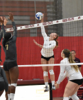 Anna Baytosh hitting a volleyball over the net