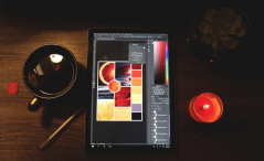 Photo of teacup, sketch tablet, and candle on desk