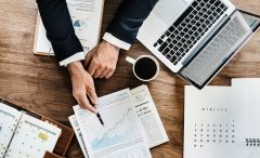 Picture of a man making a presentation around a table.