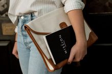 Photo by David Iskander on Unsplash, A woman holding a handbag and book