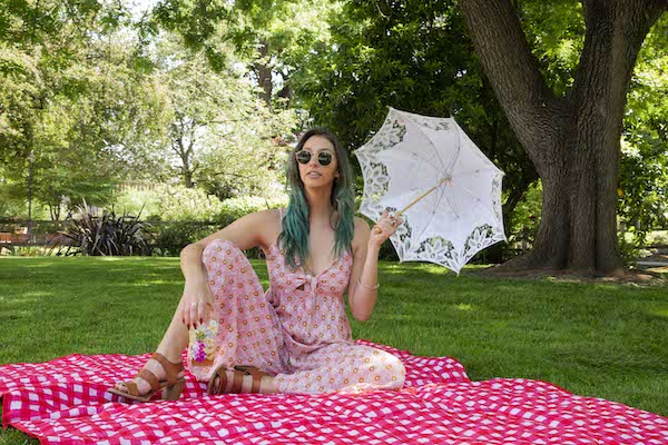 young woman posing for a portrait in a nature, picnic setting